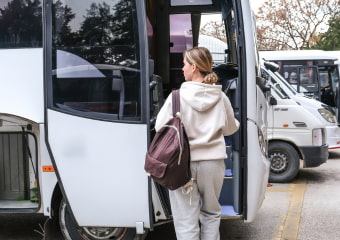 Two passengers approach a bus